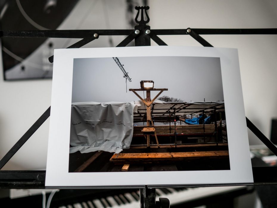 Print of carpenter's reading table on the roof of a construction site.