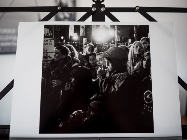 Photographic print of a woman who lights a cigarette while she is wedged in the audience during the annual Prinsengracht concert in Amsterdam. © Renske Vrolijk